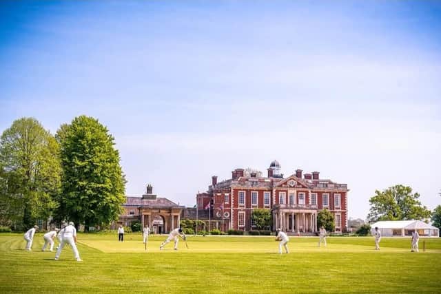 Cricket meets countryside charm: A match in full swing at the historic Stansted Park Cricket Club, set against the breathtaking backdrop of the Stansted Estate