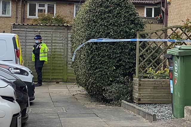 An officer stands guard outside a property in Tunstall Road, Paulsgrove, where a man was found seriously injured in a garden. Photo: Tom Cotterill