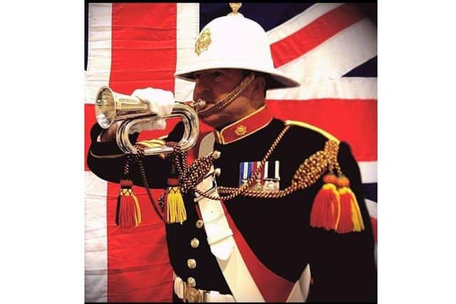 Jim Christopher with his bugle and service medals