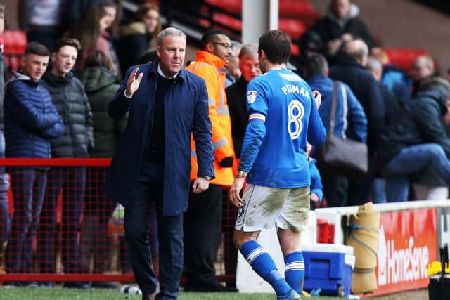 In happier times. Kenny Jackett acknowledges skipper Brett Pitman during the 2017-18 season which produced 25 goals for the striker. Picture: Joe Pepler