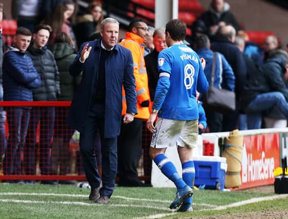 In happier times. Kenny Jackett acknowledges skipper Brett Pitman during the 2017-18 season which produced 25 goals for the striker. Picture: Joe Pepler