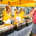 Pictured is: Bill and Maria Koraska enjoy their burgers  from the Lions Club stall
Picture: Keith Woodland (100921-6)