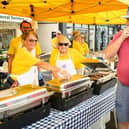Pictured is: Bill and Maria Koraska enjoy their burgers  from the Lions Club stall
Picture: Keith Woodland (100921-6)
