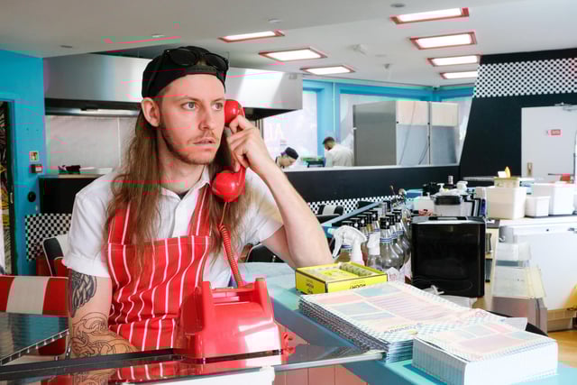A member of staff is too busy on the phone to serve his customers in Sheffield
