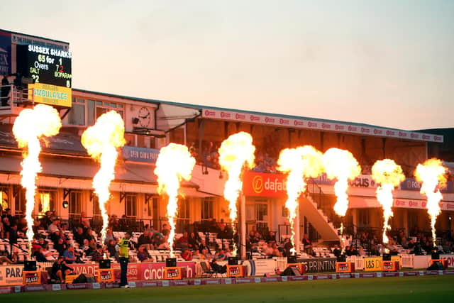 Hampshire's Joe Weatherley fields in the deep as flames light up the pavilion during the T20 Blast match between Sussex Sharks and Hampshire Hawks. Photo by Charlie Crowhurst/Getty Images.