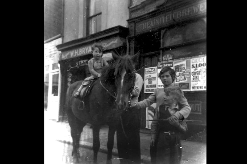 Lee Bryant on a pony outside his grandfather's paper shop WH Bryant's in Charlotte Street, Portsmouth