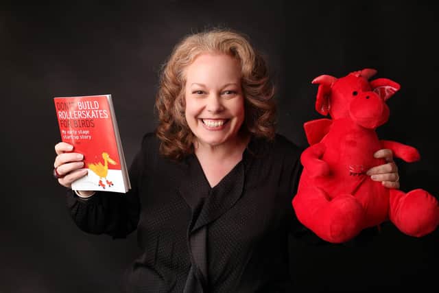Becky Lodge, founder of Startup Disruptors with her book and company mascot, Den the Dragon
