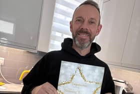 Jamie with his certificate after winning his groups icon award .