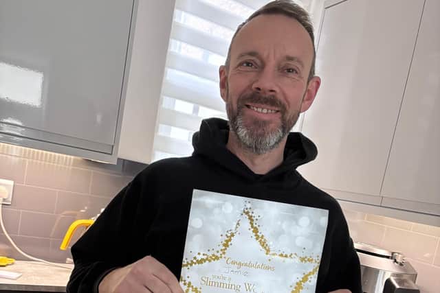 Jamie with his certificate after winning his groups icon award .