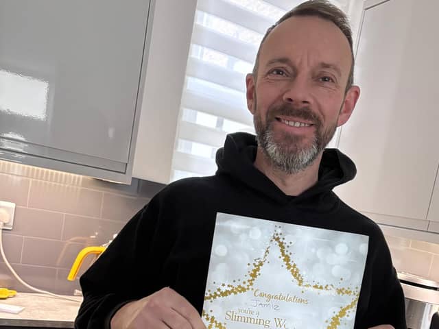 Jamie with his certificate after winning his groups icon award .