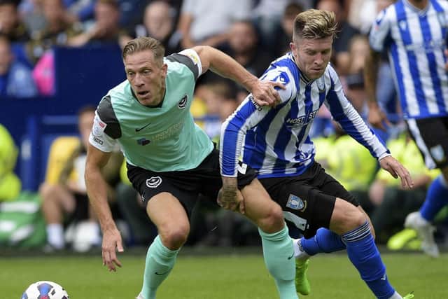 Michael Morrison battles with Sheffield Wednesday's Josh Windass on his Pompey debut last weekend. Picture: Steve Ellis