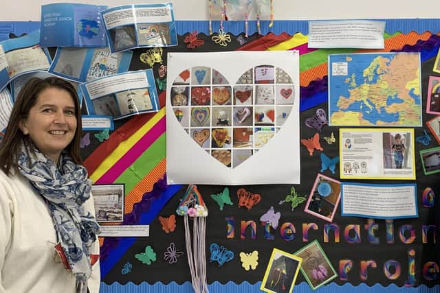 Headteacher Jane Bush (left) and teacher Lyndsey Knight with some of the images and messages of support sent  by pupils to children in Covid hotspots across Europe.