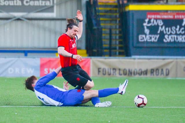 Horndean's Paul Leggett is tackled by Patrick Kerr. Picture: Bradley Pearce