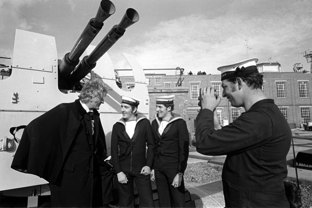 Taken 21st Oct 1971. Jon Pertwee pictured at Fraser Gunnery Range at Eastney where the BBC were filming Dr Who, The Sea Devils. Pictured with him L-R: Ordnance electrical mechanic Stephen Scholes from Leeds, control electrical mechanic Gerald Taylor from Wolverhampton (who were acting as extras in the filming), and David King from Chichester House, West Leigh is pictured taking a photo. Picture: The News 715097-2
