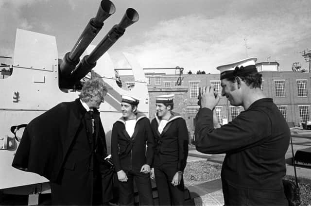 Taken 21st Oct 1971. Jon Pertwee pictured at Fraser Gunnery Range at Eastney where the BBC were filming Dr Who, The Sea Devils. Pictured with him L-R: Ordnance electrical mechanic Stephen Scholes from Leeds, control electrical mechanic Gerald Taylor from Wolverhampton (who were acting as extras in the filming), and David King from Chichester House, West Leigh is pictured taking a photo. Picture: The News 715097-2