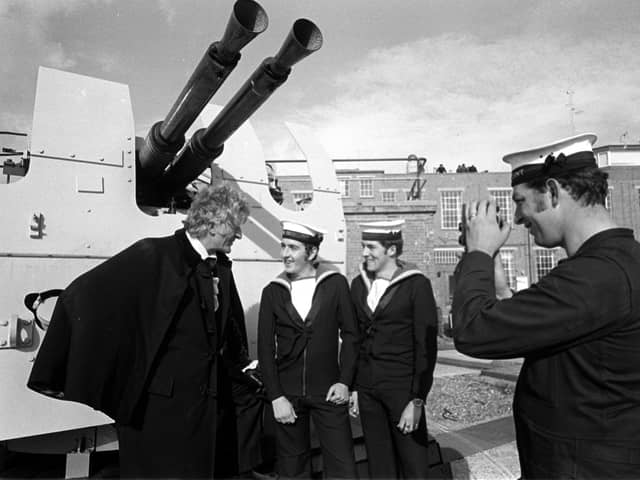 Taken 21st Oct 1971. Jon Pertwee pictured at Fraser Gunnery Range at Eastney where the BBC were filming Dr Who, The Sea Devils. Pictured with him L-R: Ordnance electrical mechanic Stephen Scholes from Leeds, control electrical mechanic Gerald Taylor from Wolverhampton (who were acting as extras in the filming), and David King from Chichester House, West Leigh is pictured taking a photo. Picture: The News 715097-2
