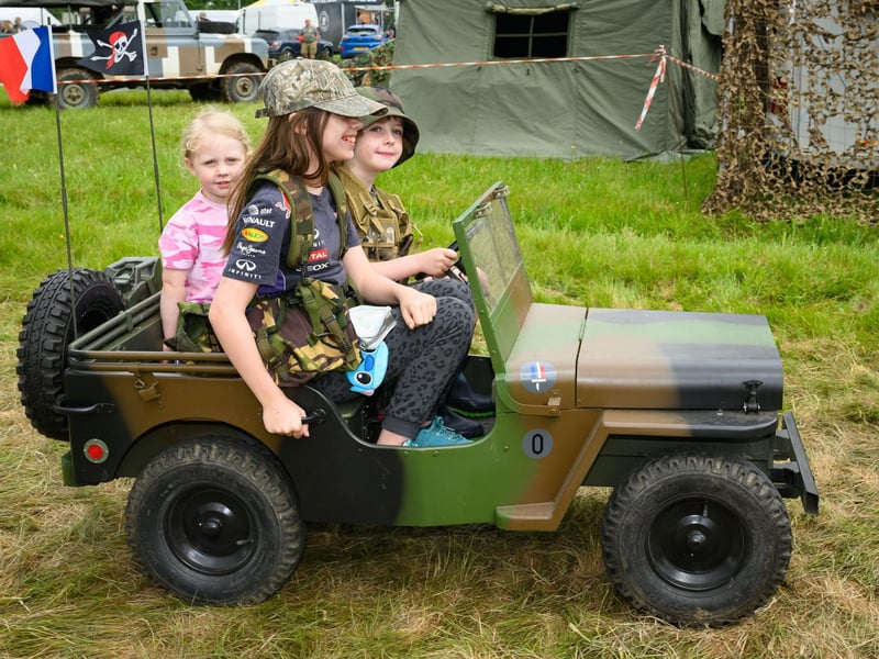 Children enjoying a toy jeep and trailerPicture: Keith Woodland (260521-82)