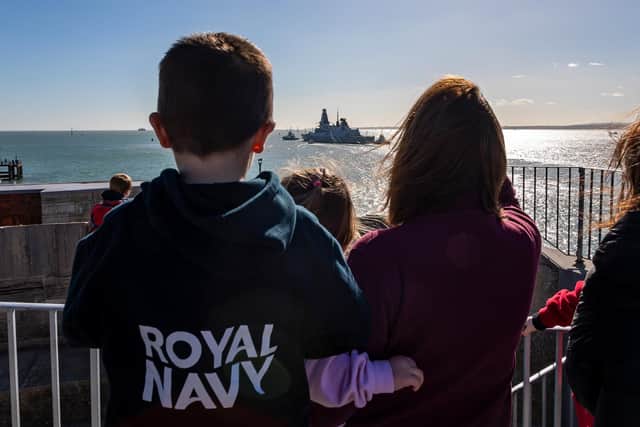 Well-wishers and families of the HMS Diamond crew gathered to see her leave Portsmouth Harbour. Picture: Mike Cooter (250222)