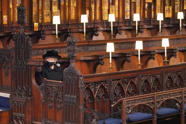 Queen Elizabeth II takes her seat for the funeral service of Britain's Prince Philip, Duke of Edinburgh inside St George's Chapel in Windsor Castle in Windsor, west of London, on April 17, 2021. (Photo by Jonathan Brady / POOL / AFP) (Photo by JONATHAN BRADY/POOL/AFP via Getty Images)