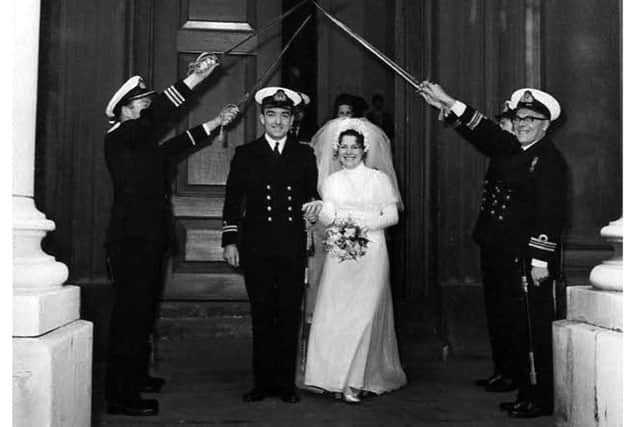 Margaret and Martin under their wedding arch in 1971.