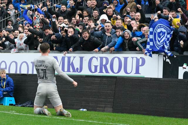 Ronan Curtis celebrates in front of the Pompey fans at Bristol Rovers earlier this season