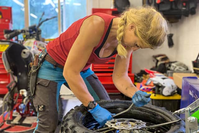 Vanessa Ruck changing a tyre on one of her bikes