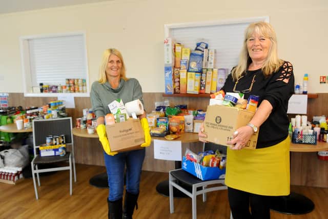 Julie Sexton, right, and her sister Penny Wilkinson pictured at AFC Portchester shortly after the launch of the Food Pantry project last April. Picture: Sarah Standing