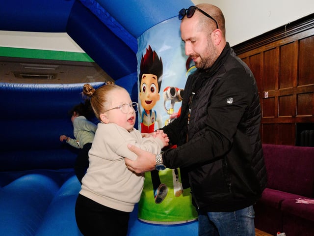 Pictured is: Marla enjoys a play on the bouncy castle with dad, Mark LangfordPicture: Keith Woodland (290921-7)
