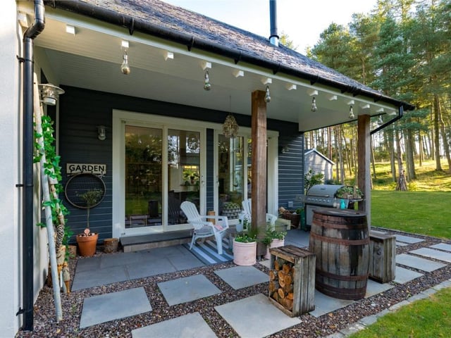 The outdoor dining area accessed from the family room is used as a barbecue area and sits under the extended roof canopy for shelter.