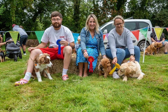 Winners of the Cutest Puppy competition line up at the Denmead Fun Dog Show. Left to right, 2nd place - Jak Enticknap (27) with Ralphie (Australian Shepherd, 5 months), 1st place - Jacqui Humphreys (42) with Rosie (cockapoo, 12 weeks old),  and 3rd place - Lara Clarke (40) with Bear (golden retriever, 6 months old). Picture: Mike Cooter (210724)
