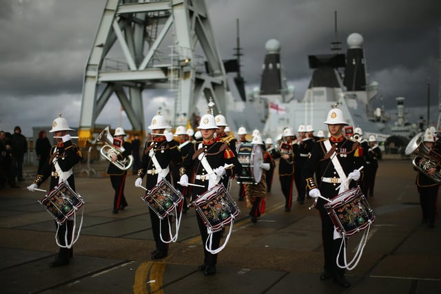 The band of the Royal Marines plays as HMS Illustrious arrives into Portsmouth Harbour on January 10, 2014 in Portsmouth. Photo by Dan Kitwood/Getty Images