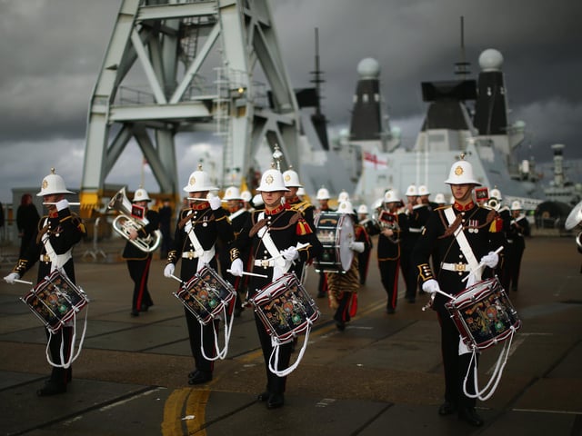 The band of the Royal Marines plays as HMS Illustrious arrives into Portsmouth Harbour on January 10, 2014 in Portsmouth. Photo by Dan Kitwood/Getty Images