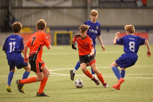 Action from the Portsmouth Youth League Stuart Madigan Cup final between Baffins Milton Rovers Vipers U14s (all blue kit) and AFC Portchester Vikings U14s (orange and black kit). Picture: Keith Woodland (190321-871)