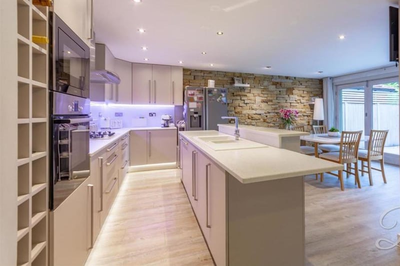 A second look at the kitchen/diner, which is open plan and a brilliant size. Among its other features are an inset sink and drainer, integrated appliances, laminate flooring and a central-heating radiator.