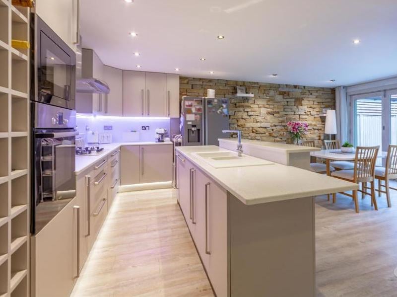 A second look at the kitchen/diner, which is open plan and a brilliant size. Among its other features are an inset sink and drainer, integrated appliances, laminate flooring and a central-heating radiator.