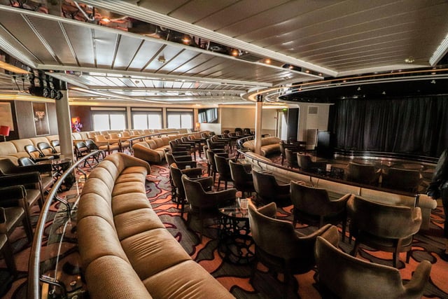 Explore the inside of Star Legend, a luxurious cruise ship operated by Windstar Cruises. Pictured is the entertainment area.