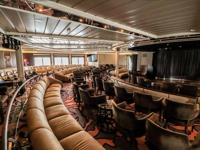 Explore the inside of Star Legend, a luxurious cruise ship operated by Windstar Cruises. Pictured is the entertainment area.