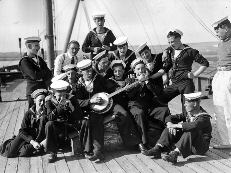 20th August 1936: Sea Cadets on board the training ship HMS Implacable at Portsmouth harbour, amuse themselves by playing some tunes. (Photo by E. Dean/Topical Press Agency/Getty Images)