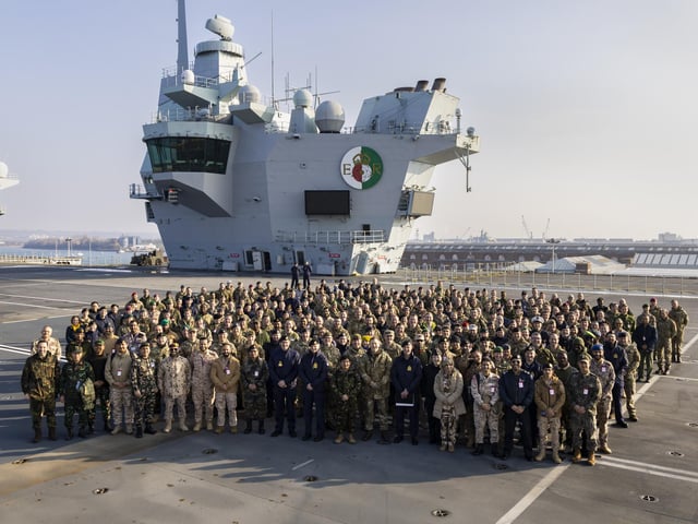 HMNB PORTSMOUTH HOSTS MARITIME COMBAT POWER VISITPictured: Group photo of the course students on the flight deck of HMS Queen Elizabeth as HMNB Portsmouth hosted the annual Maritime Combat Power Visit in March 2023 this year demonstrating how Navies globally can use the maritime domain in crisis and conflict. The purpose of the day was to show the 300 Defence Academy students (Navy, Army, Air Force and Civil Servants from around the world) and help them understand and analyse the use of maritime capability across the full spectrum of conflict and its practical application at the operational level.