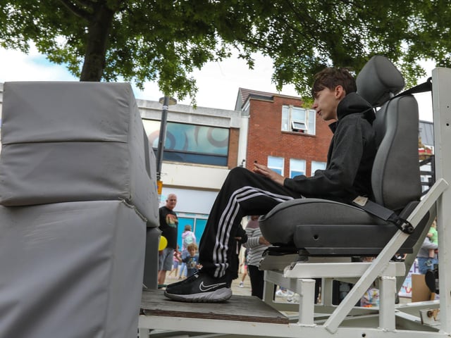Albi Burnett, 12, on the seatbelt simulator which simulates a 5 mph car crash. Fareham 999 Day, West Street, Fareham Picture: Chris  Moorhouse (220624-08)