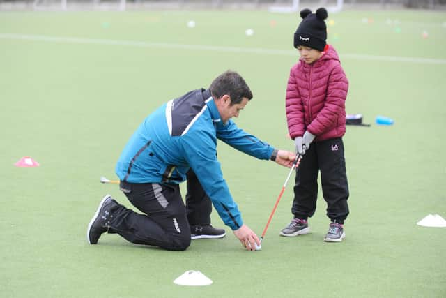 Malcolm Cooper, a golf professional at Cams Hall Estate Golf Club in Fareham, with Noemi Carmo, seven, from Whiteley.
Picture: Sarah Standing (210220-5977)