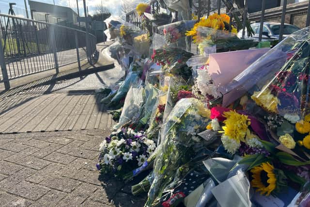 Several notes displayed with the flowers refer to the teenager as a kind, loving, and thoughtful young woman.