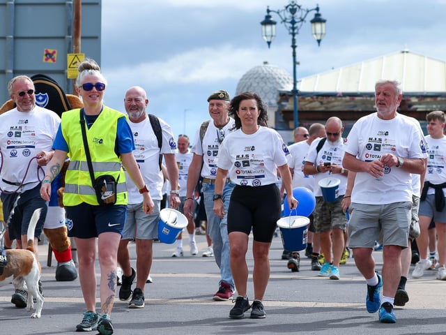 Some of those taking part in the Walk The Island event held collection buckets. Picture: Chris Moorhouse