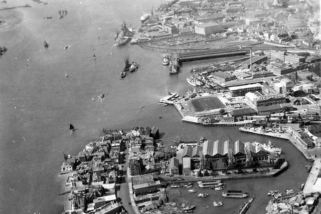 HMS Vernon (now Gunwharf) The Harbour Railway Station and South Railway Jetty with possibly HMS Vanguard alongside with the Royal Yacht astern of her.The former viaduct from the harbour station to the Jetty can also be seen.An Isle of Wight steamer is tied up alongside the station.