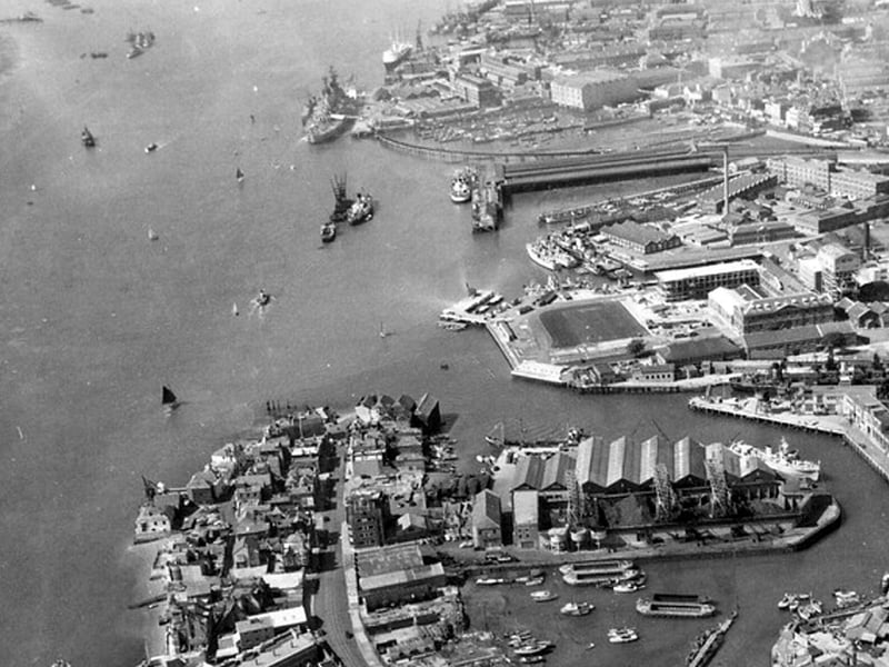 HMS Vernon (now Gunwharf) The Harbour Railway Station and South Railway Jetty with possibly HMS Vanguard alongside with the Royal Yacht astern of her. The former viaduct from the harbour station to the Jetty can also be seen. An Isle of Wight steamer is tied up alongside the station.