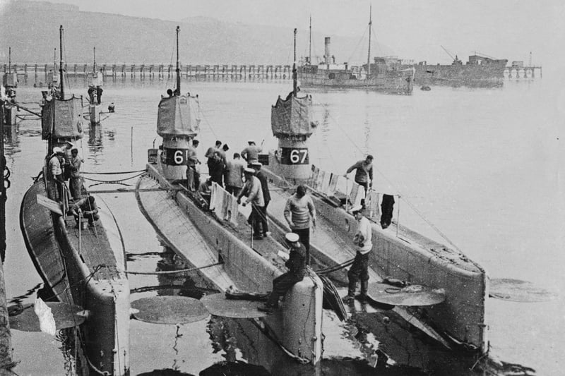 Officers and crew stand on deck and around the conning towers of the Royal Navy C-class  petrol engined submarines HMS C36, C37, and C38 ( marked 66,68 and 67)  as they make preparations at Fort Blockhouse submarine base near Gosport for the voyage to the China Station in Hong Kong on 8 February 1911 off Gosport, United Kingdom.  (Photo by Paul Thompson/FPG/Getty Images)