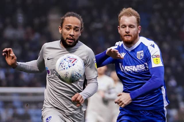 Pompey;s Marcus Harness under pressure from Connor Ogilvie of Gillingham. Picture: Jason Brown