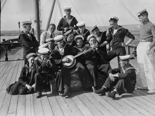 20th August 1936:  Sea Cadets on board the training ship HMS Implacable at Portsmouth harbour, amuse themselves by playing some tunes.  (Photo by E. Dean/Topical Press Agency/Getty Images)