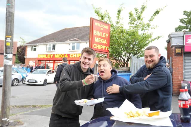 Customers L-R Jake, Tom and Josh from Portsmouth eating their chips outside Binley Mega Chippy in Coventry. Picture: SWNS.
