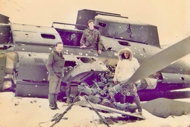 Ian Tennant, pictured standing inside a crashed helicopter on South Georgia, during the Falklands Wa